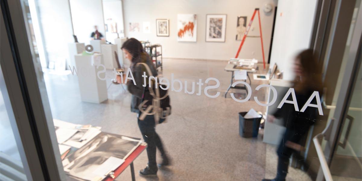 Visitors enter an AACC student art exhibit.